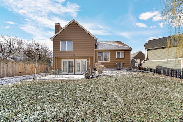 back of property featuring a lawn, french doors, and a patio area