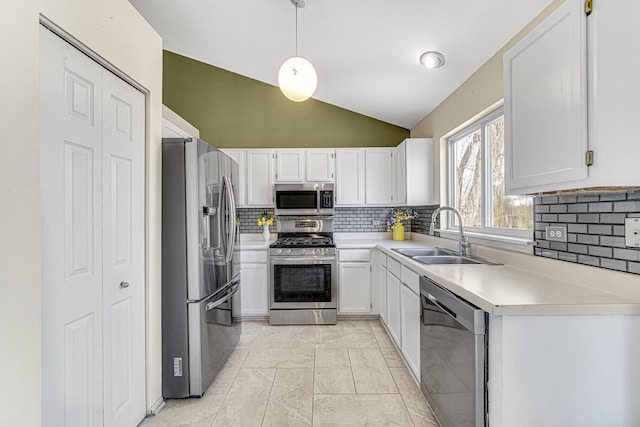 kitchen with sink, white cabinets, lofted ceiling, and stainless steel appliances