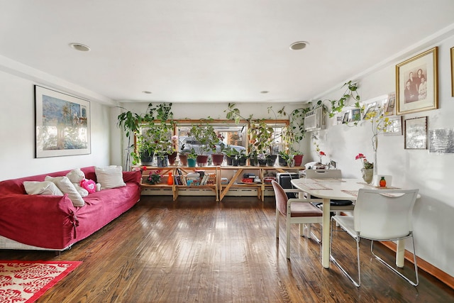 dining space with dark hardwood / wood-style flooring and a wall mounted air conditioner