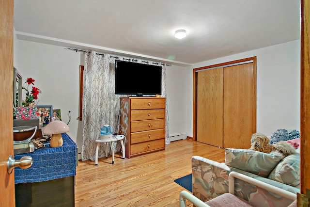 interior space featuring hardwood / wood-style flooring and a baseboard heating unit