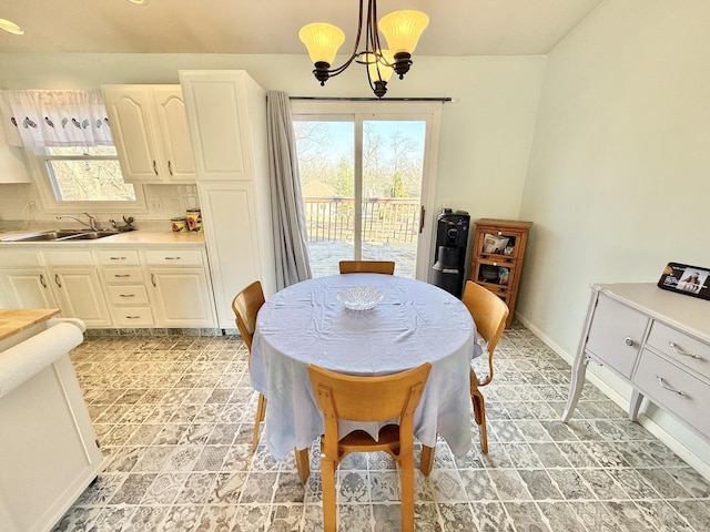 dining area featuring a chandelier and sink