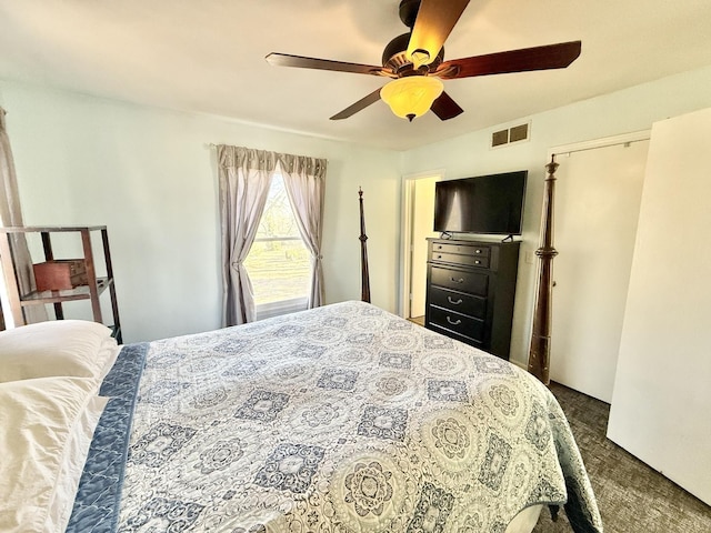 bedroom with ceiling fan and dark colored carpet