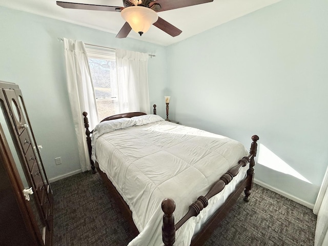 bedroom featuring ceiling fan and dark carpet