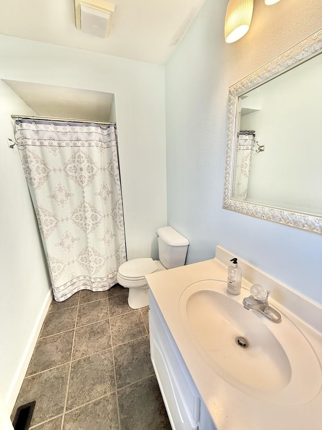 bathroom featuring toilet and vanity