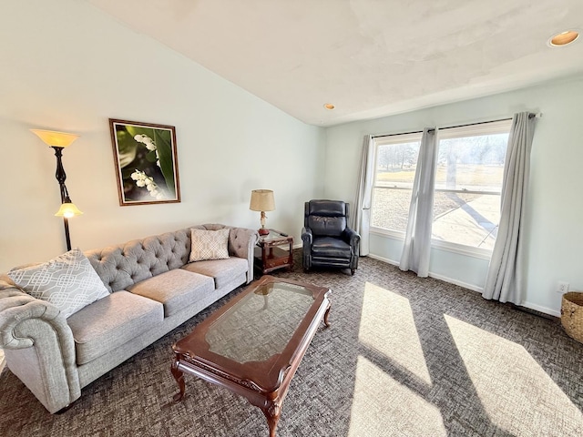 carpeted living room with lofted ceiling