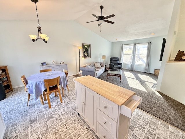 interior space with ceiling fan with notable chandelier and vaulted ceiling