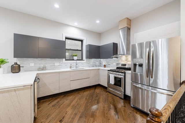 kitchen with gray cabinetry, stainless steel appliances, wall chimney exhaust hood, and sink