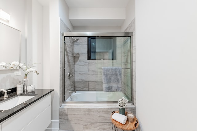 bathroom featuring vanity and bath / shower combo with glass door