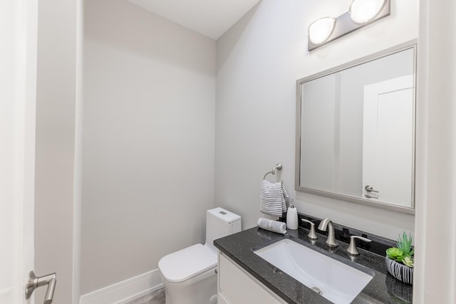 bathroom with toilet and vanity