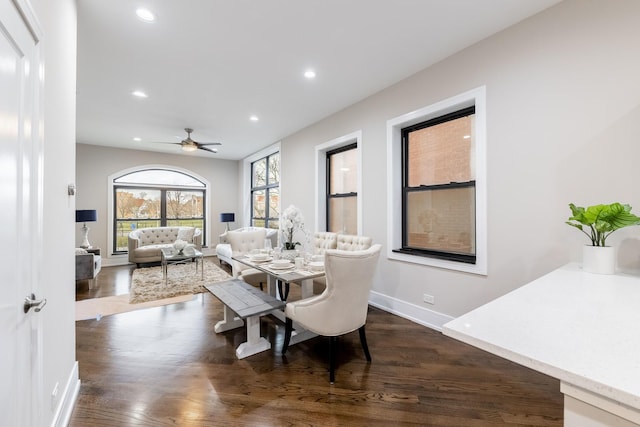 dining area featuring ceiling fan and dark hardwood / wood-style flooring