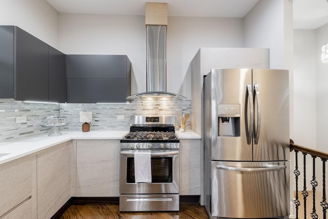 kitchen featuring tasteful backsplash, wall chimney exhaust hood, stainless steel appliances, and dark wood-type flooring