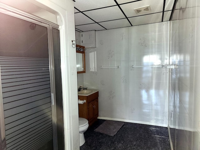 bathroom with toilet, vanity, and a paneled ceiling