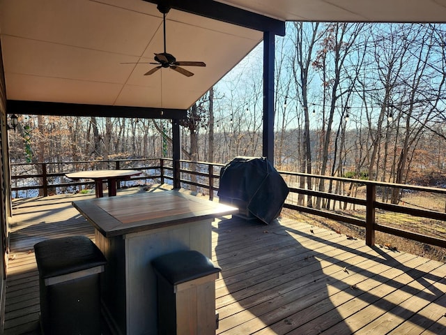 wooden deck featuring ceiling fan and area for grilling