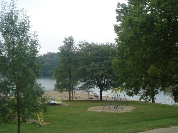 view of home's community with a playground and a yard