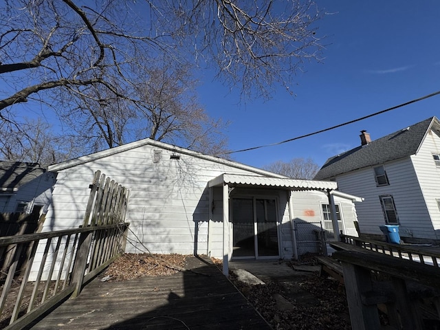 rear view of property featuring a wooden deck