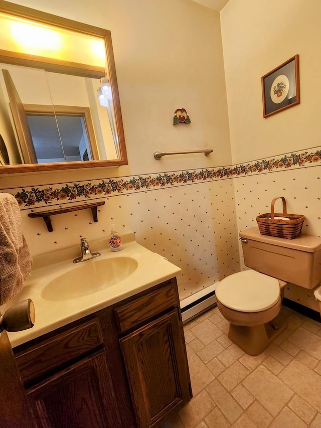 bathroom with a baseboard radiator, toilet, and vanity