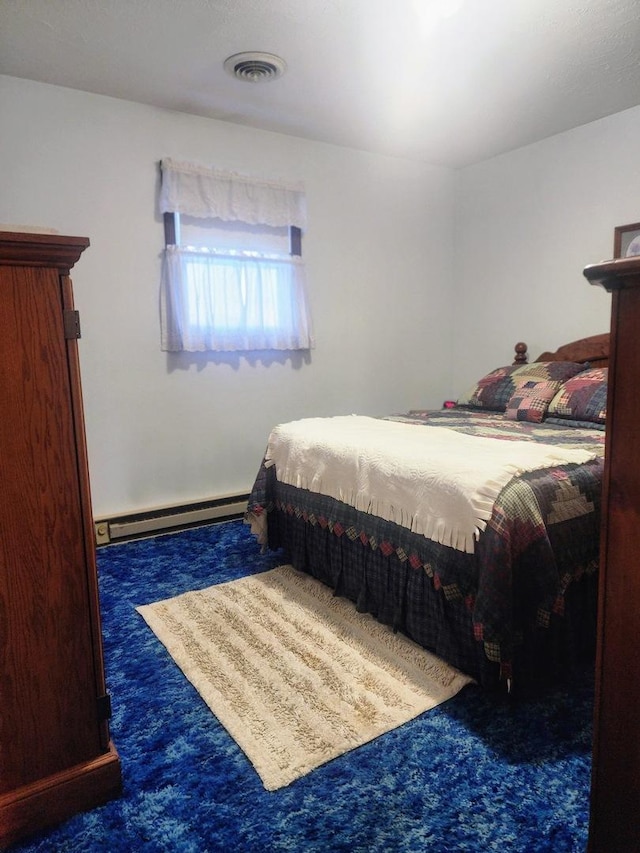 carpeted bedroom with a baseboard heating unit