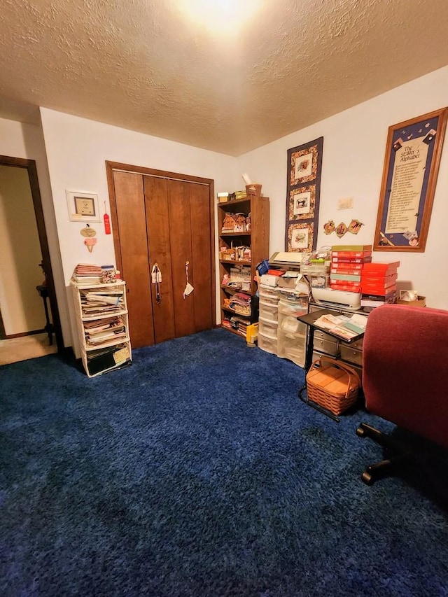 office space featuring carpet floors and a textured ceiling