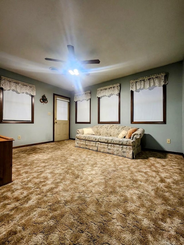 unfurnished living room featuring carpet and ceiling fan