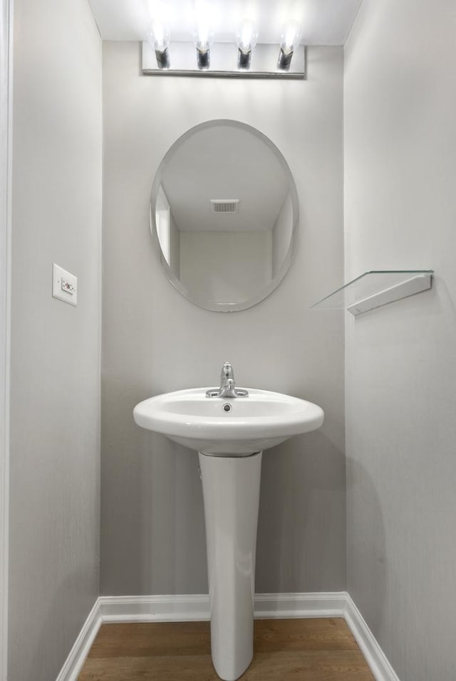 bathroom featuring hardwood / wood-style flooring and sink