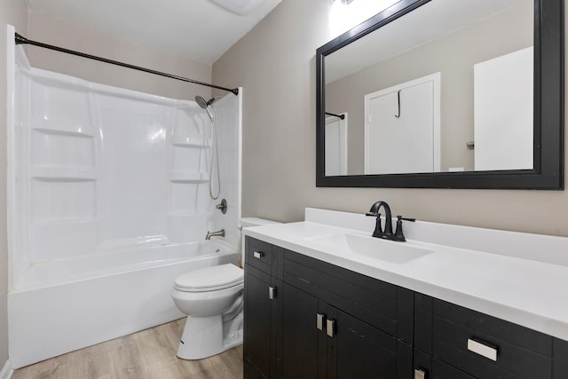 full bathroom with bathtub / shower combination, wood-type flooring, toilet, and vanity