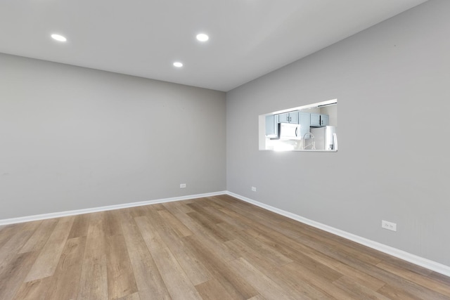 spare room with light wood-type flooring