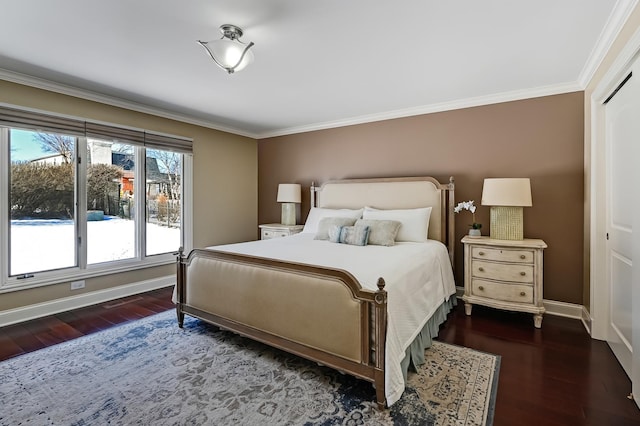 bedroom featuring dark wood-type flooring, crown molding, and baseboards