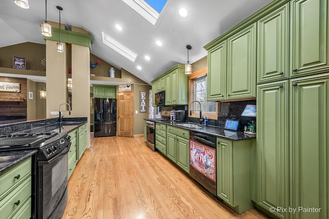 kitchen with decorative light fixtures, green cabinets, and black appliances