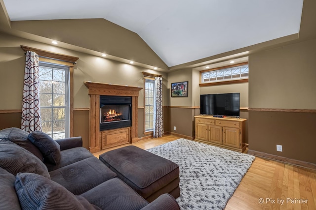 living room featuring light hardwood / wood-style floors and lofted ceiling