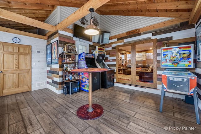 interior space featuring lofted ceiling, wooden walls, and hardwood / wood-style floors