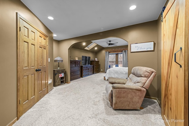 carpeted bedroom with a barn door