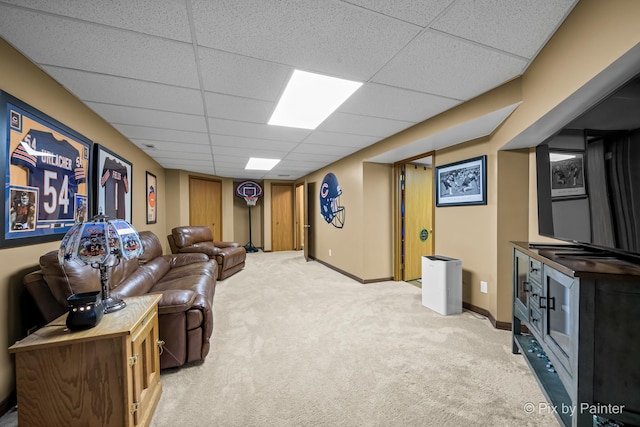 carpeted living room with a paneled ceiling