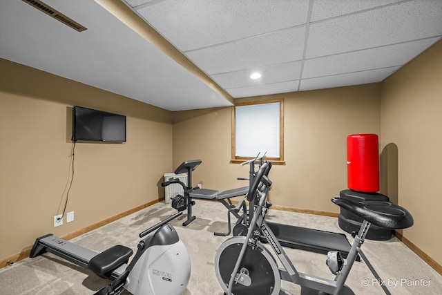 workout room with a paneled ceiling and carpet flooring