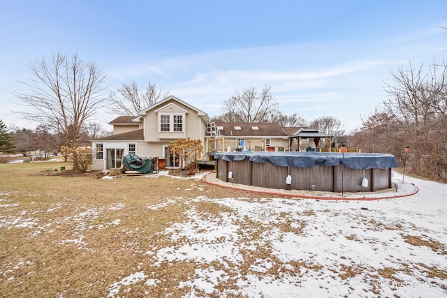 snow covered property with a covered pool