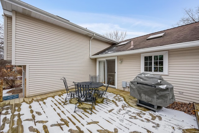 snow covered deck featuring area for grilling