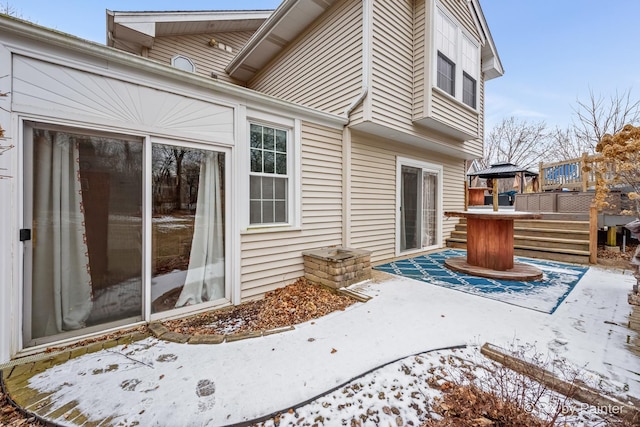 snow covered patio featuring a deck and a gazebo