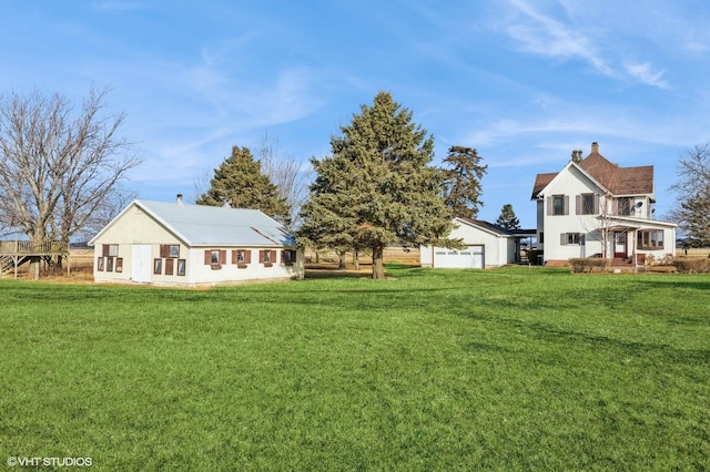 view of yard with a garage and an outdoor structure