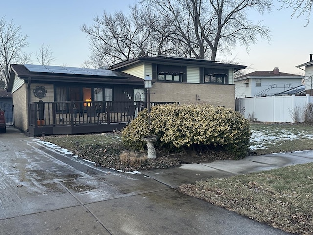 view of front of home featuring solar panels