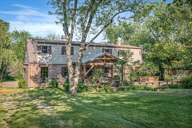 back of property featuring a yard and a patio