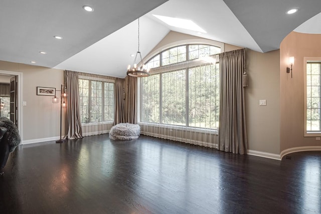 unfurnished living room with a chandelier, lofted ceiling, and dark hardwood / wood-style flooring