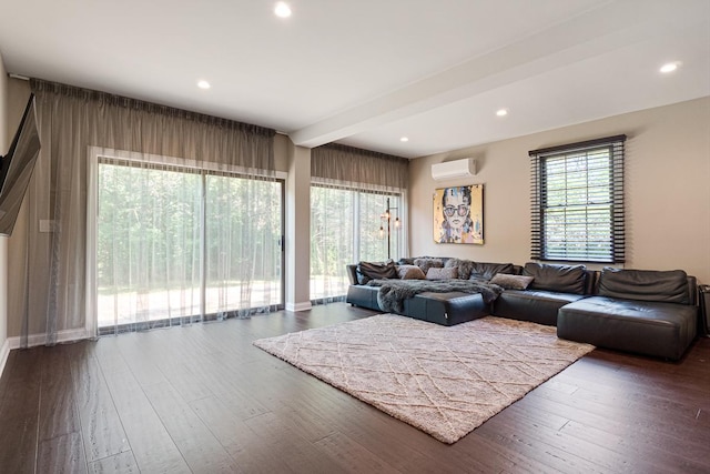 living room with dark wood-type flooring, a wall mounted AC, and beam ceiling