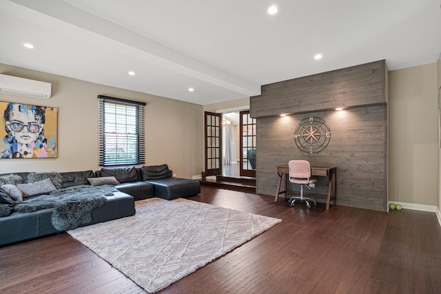 living room with dark hardwood / wood-style floors and a wall unit AC