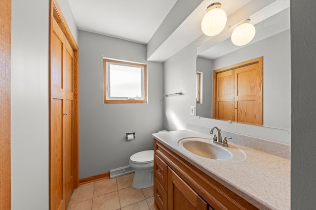 bathroom featuring tile patterned flooring, toilet, visible vents, vanity, and baseboards