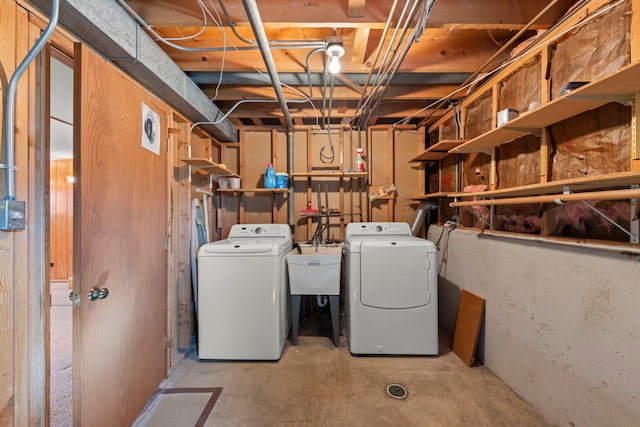 washroom featuring laundry area, a sink, and washing machine and clothes dryer