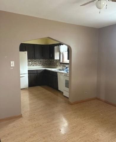 kitchen with white fridge, ceiling fan, and decorative backsplash