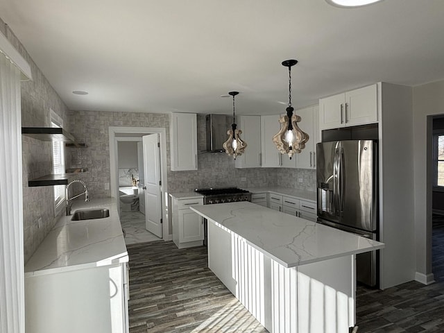 38W715 Huntley Rd, West Dundee, IL 60118 - kitchen featuring wall chimney exhaust hood, stainless steel refrigerator with ice dispenser, a center island, and light stone counters