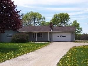 38W715 Huntley Rd, West Dundee, IL 60118 - ranch-style house featuring driveway, a garage, a front yard, and a chimney