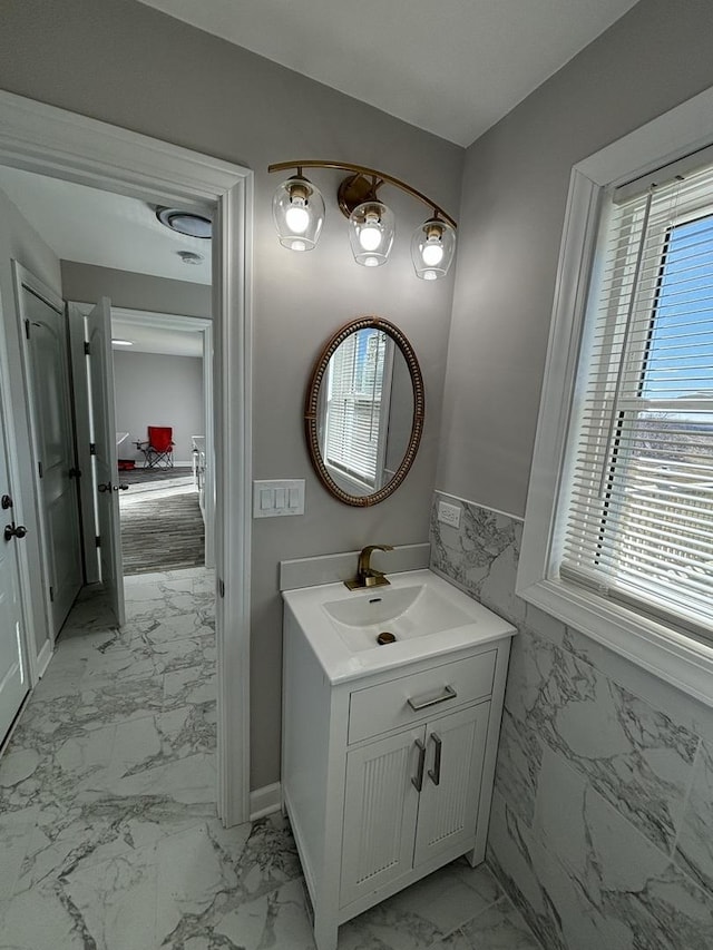 bathroom with vanity and tile walls