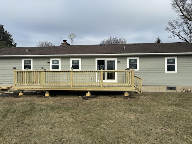 back of house featuring a deck and a lawn