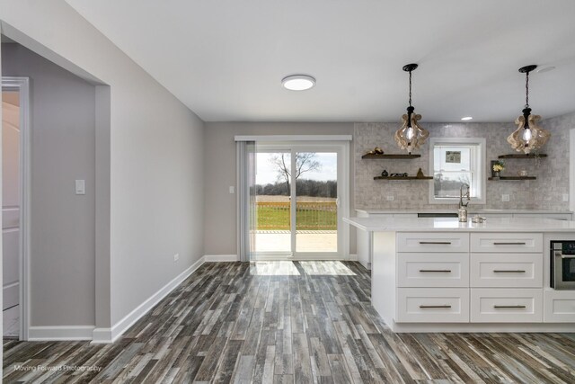 38W715 Huntley Rd, West Dundee, IL 60118 - kitchen with open shelves, light countertops, dark wood-style floors, and decorative light fixtures